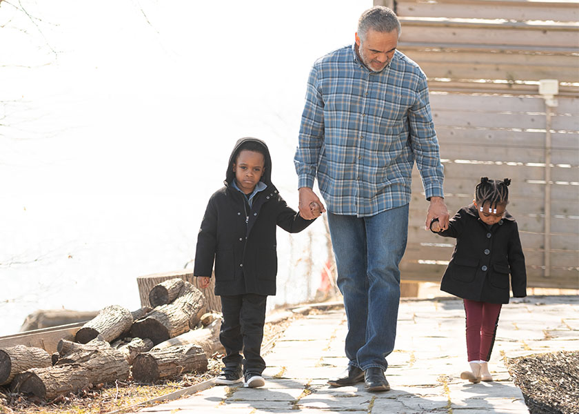 Grandfather walking with grandkids